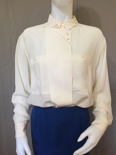 980s button up blouse 100% silk, mother of pearl buttons, false lapel button front. Perfect condition, never worn. Classic Blouse With Lapel Collar And Buttons, Silk Button-up Shirt For Office, Elegant Tops With Buttons And Collared Neckline, Classic Silk Blouse For Formal Occasion, Cream Silk Top For Workwear, Formal Blouse With Lapel Collar And Placket, Silk Office Blouse With Button Closure, Silk Blouse With Button Closure For Office, Chic Collared Blouse With Covered Buttons