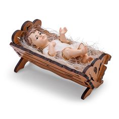 a baby doll laying on top of a wooden sleigh