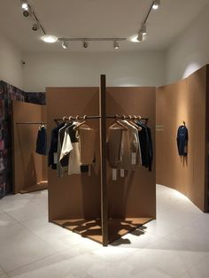 an open room with clothes on hangers in it