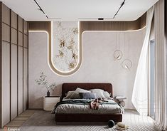 a large bed sitting under a window next to a wall mounted light above it's headboard