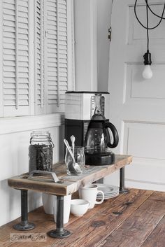 a coffee maker sitting on top of a wooden table