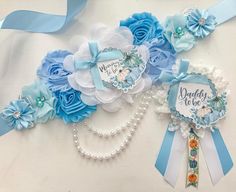 blue and white wedding garters with pearls, ribbons and flowers on the side