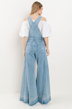 Choose comfort and style with the Women's Distressed Wide Leg Denim Overall. The adjustable straps, kangaroo chest pocket, and front and back pockets provide convenience, while the wide western legs, side buttons, and distressed accents add a trendy touch. Stay on trend in these comfortable, boho-inspired overalls. 34" INSEAM SLEEVELESSBUCKLE CLOSUREADJUSTABLE STRAPSKANGAROO CHEST POCKETFRONT/BACK POCKETSWIDE LEG Wide Leg Light Wash Overalls With Pockets, Medium Wash Wide-leg Overalls With Pockets, Spring Jeans With Adjustable Straps, Medium Wash Denim Jeans With Suspenders, Spring Utility Jeans With Bib Front, Light Wash Overalls With Pockets For Fall, Fall Light Wash Overalls With Pockets, Casual Spring Jeans With Adjustable Straps, Casual Jeans With Adjustable Straps For Spring