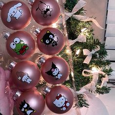 a christmas tree decorated with red ornaments and cartoon characters on it's sides, in front of a white background