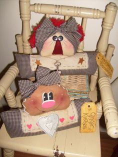 a teddy bear sitting on top of a wooden rocking chair with other items around it