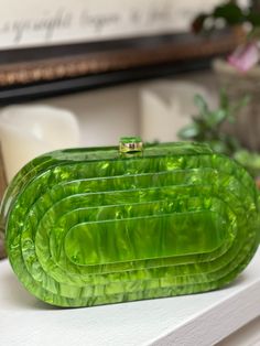 This pearlized resin clutch in agave green has an art deco flare that will add sophistication to any of your looks Can be worn as a clutch or Crossbody Measuring 8.25 x 4.5 “ This purse fits an iPhone plus Luxury Green Rectangular Clutch, Trendy Green Clutch As A Gift, Trendy Green Clutch As Gift, Trendy Green Clutch For Gift, Luxury Green Clutch Evening Bag, Chic Green Rectangular Evening Bag, Trendy Green Rectangular Clutch, Trendy Green Clutch For Formal Occasions, Chic Green Evening Bag For Formal Events