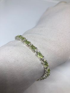 This Peridot bracelet is very lively and bright. The stones are deep colors and well matched. The sterling silver is plated with rhodium to protect the bracelet from tarnish and give the appearance of white gold. 8 inches for a larger wrist My jeweler can shorten it All jewelry is shipped in a nice gift box. Check out our over a THOUSAND great reviews Engraving is $4 per letter and is not always perfect depending on the piece. It can take a few days if the jeweler is busy. This is payable to Pay Silver Tennis Bracelet, Peridot Bracelet, Deep Colors, Tennis Bracelet, Chain Link Bracelet, Diamond Bracelet, Tennis, Best Gifts, Gift Box