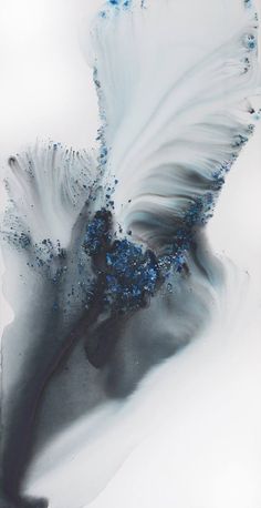 an abstract painting with blue and white feathers on it's back side, against a gray background