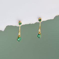 A pair exquisite vintage gold Art Deco drop earrings with 2 emerald stones on each. A perfect gift for a special occasion, such as birthdays, anniversaries or simply a treat to yourself. The earrings are crafted in 14k gold vermeil  (Sterling silver base and thick 14K white gold or yellow gold on top), ensuring it to keep its lustre for longer.   MATERIAL  ☽ Main Material: 925 Sterling silver ☽ Finish: 14K White Gold or Yellow Gold This design is also available in Ruby gold and silver earrings: Green Linear Drop Earrings For Formal Occasions, Elegant Teardrop Earrings For May Birthstone Gift, May Birthstone Teardrop Earrings, Elegant Green Dangle Linear Earrings, Gold Dangle Teardrop Earrings For May Birthstone, Elegant Green Drop Linear Earrings, Elegant Green Linear Earrings As Gift, Elegant May Birthstone Dangle Teardrop Earrings, Elegant Dangle Teardrop Birthstone Earrings