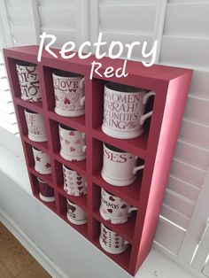 a red shelf with coffee mugs on it