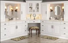 a large bathroom with white cabinets and mirrors