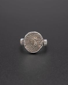 Add a little history and a touch of intrigue with this vintage silver Hindu shahi coin ring. Coiled in silver, this is a unique signet-style ring. Vintage Engraved Coin Signet Ring, Handmade Sterling Silver Signet Ring For Ceremonial Occasions, Handmade Sterling Silver Signet Ring For Ceremonial Use, Silver Byzantine Engraved Ring, Ceremonial Silver Hand Forged Rings, Ceremonial Hand Forged Silver Rings, Ceremonial Heirloom Silver Signet Ring, Vintage Hand Forged Sterling Silver Signet Ring, Silver Byzantine Rings Hallmarked