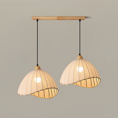 two lights hanging from a wooden ceiling fixture