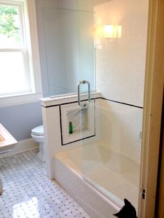 a white bath tub sitting next to a window