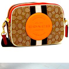 This Is An Authentic Coach Bag. I Posted A Picture Of The Tag Of Authenticity :) It Was A Gift Used 3 Times And Got Compliments. In Great Condition. Coach Orange Crossbody Shoulder Bag, Orange Rectangular Bag With Branded Hardware, Luxury Orange Pouch Shoulder Bag, Orange Rectangular Shoulder Bag With Branded Hardware, Orange Rectangular Bags With Branded Hardware, Coach Orange Crossbody Bag, Travel Shoulder Bag With Branded Hardware In Orange, Orange Shoulder Bag With Branded Hardware For Travel, Coach Orange Satchel Bag