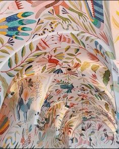 an intricately painted ceiling in a building with many different colors and designs on it