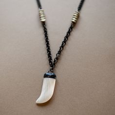 I live for this necklace. All components found in Tucson from the coolest vendors - a killer handmade chain company in California, an even cooler husband and wife hand-soldering team in Arizona, and brass from Africa. This necklace features a hand-soldered tiger claw - I think it's bone but they said it was mother of pearl. Either way it's from the 70s and glorious. I used two sizes of gunmetal plated brass chain, separated them by African brass over copper beads and finished with a gunmetal tog Brass Claw Jewelry As Gift, Artisan Soldered Brass Necklaces, Tiger Claw, Handmade Chain, Month Gifts, They Said, Gift Card Giveaway, Brass Chain, Soldering