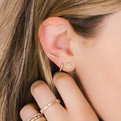 These pavé-set diamond and gold mini huggie earrings are a perfect size for those looking to fill 2nd, 3rd, 4th etc. piercings, or for those with petite earlobes. These diamond huggies hug your earlobe just right and are a brilliant addition to your ear stack. For most people, the mini huggies will fit in your second or third piercing, but some can wear these in their first hole. These diamond huggie earrings are the everyday staple earrings you've been hunting for. They are a favorite of the Da Staple Earrings, Earrings Diamonds, Dana Rebecca Designs, Diamond Huggie Earrings, Diamond Huggies, Daisy Bracelet, Ear Stack, Buddha Pendant, Climber Earrings