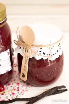 two jars filled with jam sitting on top of a table