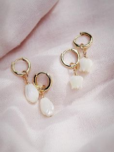 The Lei Hoops reflect Hawaii's natural abundance and beauty. These small gold mother of pearl and gold huggie hoop earrings feature darling carved seashell flower charms reminiscent of Hawai'i's flower leis. These pretty gold hoops are perfect solo or teamed with our some huggie hoops.Handmade on Maui, Hawaii. ✦ Choose from two flower styles: Tulip or Pikake ✦✦ DETAILS ✦✧ Name: Lei (LAEE) - garland.✧ 18kt Gold Vermeil.✧ 25mm & 29mm Drop Length✧ 12mm hoop outer diameter, 9mm inner diameter, & 2.5 Dainty White 14k Gold Filled Huggie Earrings, Huggie Earrings With Flower Charm For Gift, Small Hoop White Huggie Earrings In 14k Gold, White 14k Gold Filled Huggie Earrings, Flower Charm Huggie Earrings As Gift, Gift Jewelry Flower Charm Huggie, Huggie Jewelry With Flower Charm For Gift, Huggie Jewelry With Flower Charm As Gift, Gift Huggie Hoop Earrings With Flower Charm