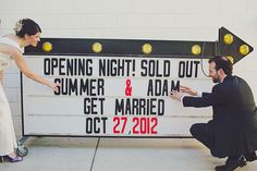 a man kneeling down next to a woman in front of a sign that says opening night sold out summer & adam get married oct 27, 2012