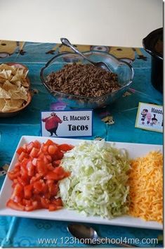 a table topped with plates and bowls filled with different types of food on top of it