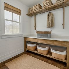 a wooden bench sitting next to a window filled with baskets on top of it's sides