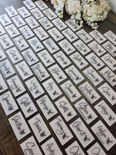 the table is covered with place cards and flowers