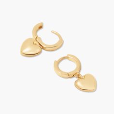 Love is in the air with these golden heart earrings. Showcase your sparkle and make a statement with these perfect pair of hearts – they'll bring the perfect hint of romance to any outfit. Available in 14k gold plated brass 1/2" huggie with 3/8" charm Hinge closure Protected with an anti-tarnish barrier SKU: BYE1165 Tarnish Resistant Heart Huggie Earrings, Dainty Heart-shaped Tarnish-resistant Huggie Earrings, Trendy Gold Hypoallergenic Heart Earrings, Gold-tone Huggie Earrings, Dainty Tarnish-resistant Huggie Heart Earrings, Trendy Huggie Earrings For Valentine's Day, Trendy Huggie Heart Earrings With Heart Charm, Tarnish Resistant Huggie Heart Earrings, Gold Huggie Heart Earrings Trendy