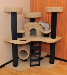 a cat sitting on top of a scratching tower in a room with wooden floors and walls