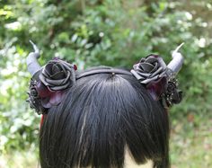 These handmade horns are perfect for any convention, renaissance festival, fantasy event, art show or the perfect accessory for your night out on the town! They are light and comfortable and will fit most adults and children. You may choose between black colored horns or bone colored. The types of flowers will vary depending on what we have in stock but the color scheme will remain the same as the one ordered. If you're looking for a specific color scheme that is not listed you can choose to ord Black Whimsical Headpiece For Festival, Black Whimsical Festival Headpiece, Whimsical Black Festival Headpiece, Gothic Black Costume Accessories With Ears, Black Fantasy Costume Accessories With Ears, Fantasy Black Costume Accessories With Ears, Horned Costume Accessories For Costume Party, Adjustable Horned Fantasy Headpiece, Horned Fantasy Headpiece For Festival