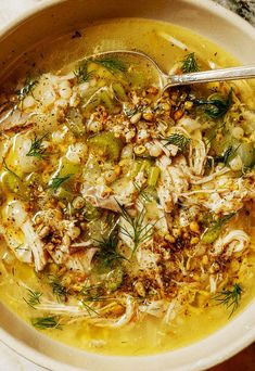 a white bowl filled with chicken and vegetable soup