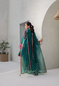 Same color co-Ord sets are in for the season. Stand out in this pepper green cotton net box cut kurta, embellished and worked with kamdani. The matching raw silk trousers have worked detailing. The organza dupatta is finished with kamdani detailing in starry details. Silk Trousers, Website Features, Organza Dupatta, How To Dye Fabric, Stuffed Green Peppers, Raw Silk, Co Ord, Green Cotton, Boutique Dresses