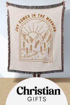 a tapestry with the words christian gifts on it and an image of mountains in the background