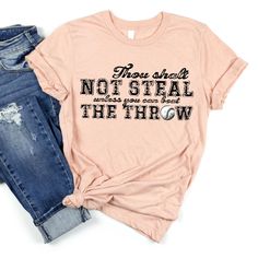 a t - shirt that says, they shall not steal the throw with ripped jeans