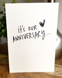 a card with the words it's our anniversary written on it