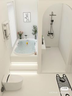 a white bathroom with a tub and toilet