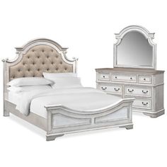 a white bed sitting next to a dresser and mirror