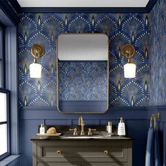 a bathroom with blue and gold wallpaper, two sinks and a large mirror on the wall