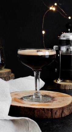 a drink sitting on top of a wooden coaster