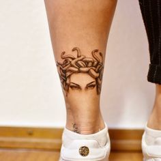 a woman's legs with tattoos on them and an octopus tattooed on her leg