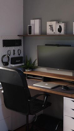 a desk with a computer monitor, keyboard and mouse