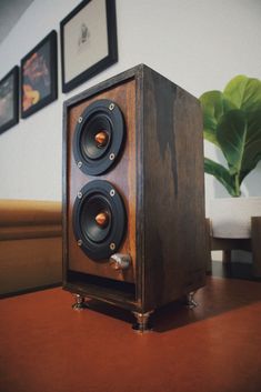 a wooden speaker sitting on top of a table