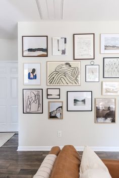 a living room filled with lots of pictures on the wall