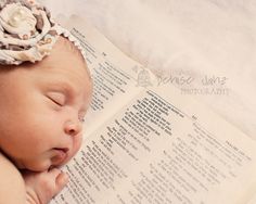 a baby sleeping on top of an open book