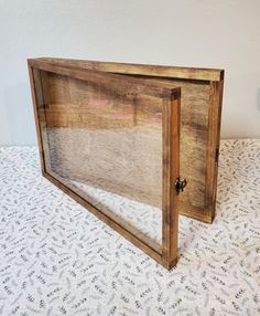 a wooden frame sitting on top of a bed