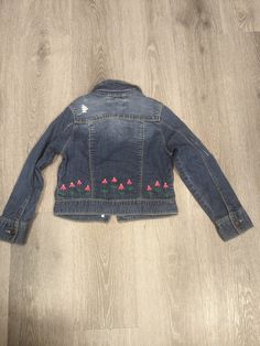 Hand embroidered pink flowers on a Jean jacket. Size 10 (L) girls. Spring Long Sleeve Outerwear With Floral Applique, Spring Outerwear With Floral Applique And Long Sleeve, Spring Floral Applique Long Sleeve Outerwear, Casual Cotton Outerwear With Floral Applique, Spring Cotton Outerwear With Floral Applique, Pink Cotton Outerwear With Floral Embroidery, Fitted Pink Outerwear With Floral Embroidery, Spring Pink Outerwear With Floral Embroidery, Pink Floral Embroidered Outerwear For Spring