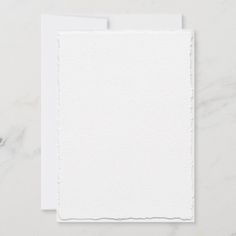 two blank cards with white paper on them