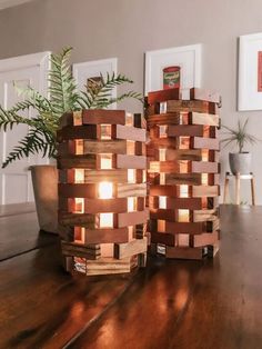 two wooden vases sitting on top of a table next to a potted plant