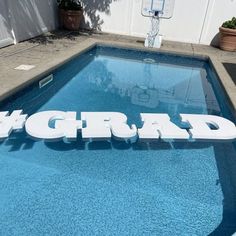 a swimming pool with the word grad written in white on it's side